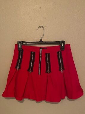 Dolls Kill ‘Current Mood’ red pleated mini skirt with black zipper details